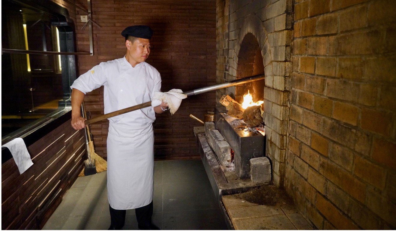 Chef Liu Bo roasting a duck at Jing Yaa Tang in Beijing. Photo: Tom Wang