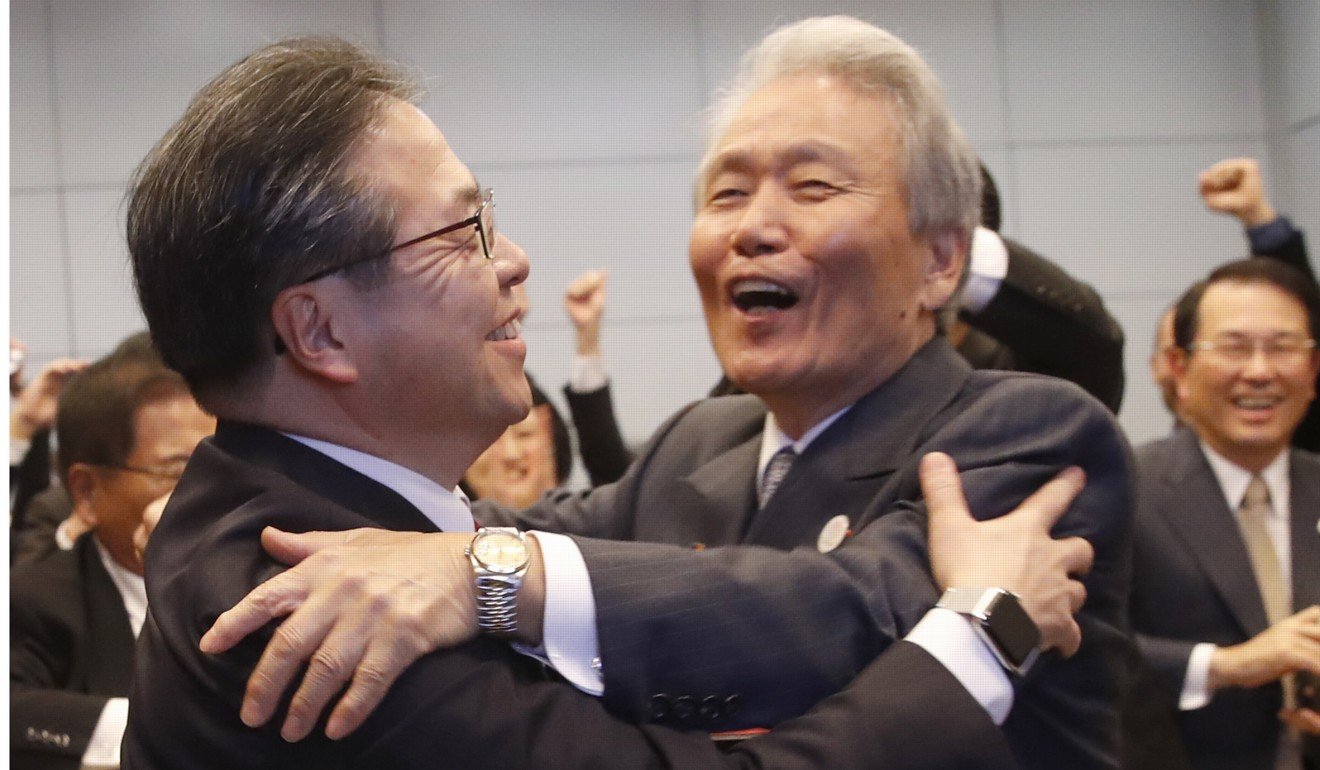 Japan's Economy, Trade and Industry Minister Hiroshige Seko (left) and head of 2025 Japan World Expo committee Sadayuki Sakakibara celebrate after winning the vote in Paris on Friday. Photo: AP