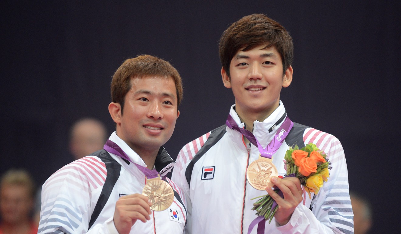 Jung Jae-sung and Lee celebrate winning bronze medals at the 2012 Olympic Games in London. Photo: AFP