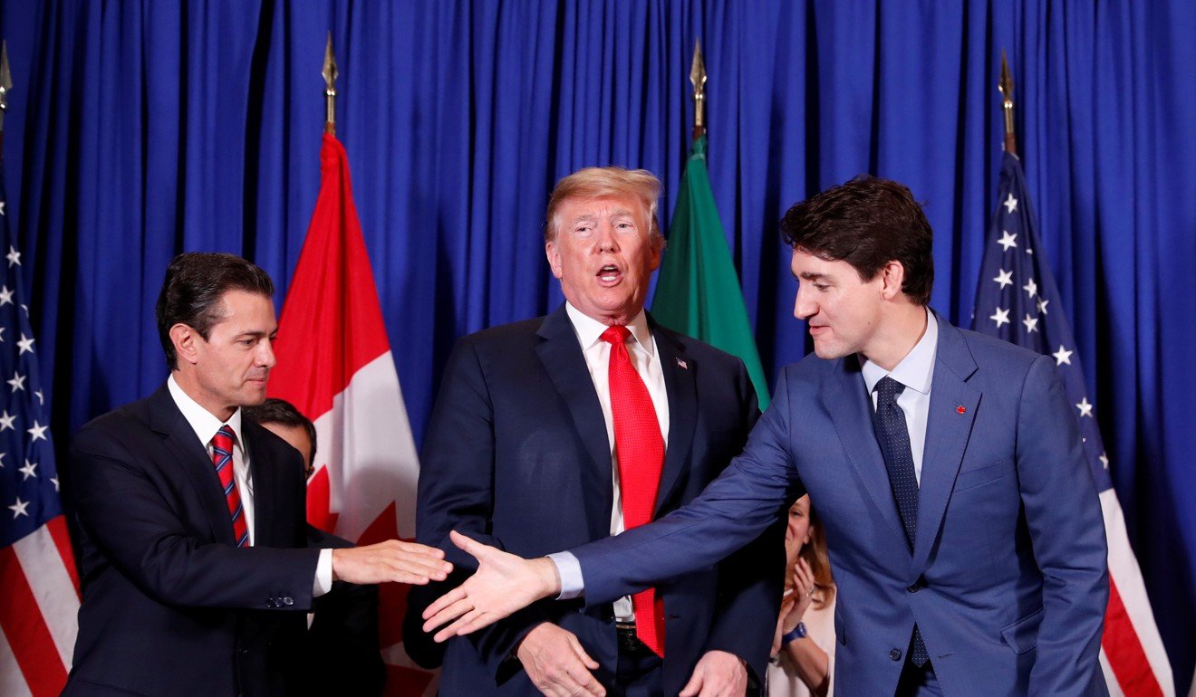Nieto and Trudeau shaking hands at the signing in a hotel in Buenos Aires. Photo: Reuters