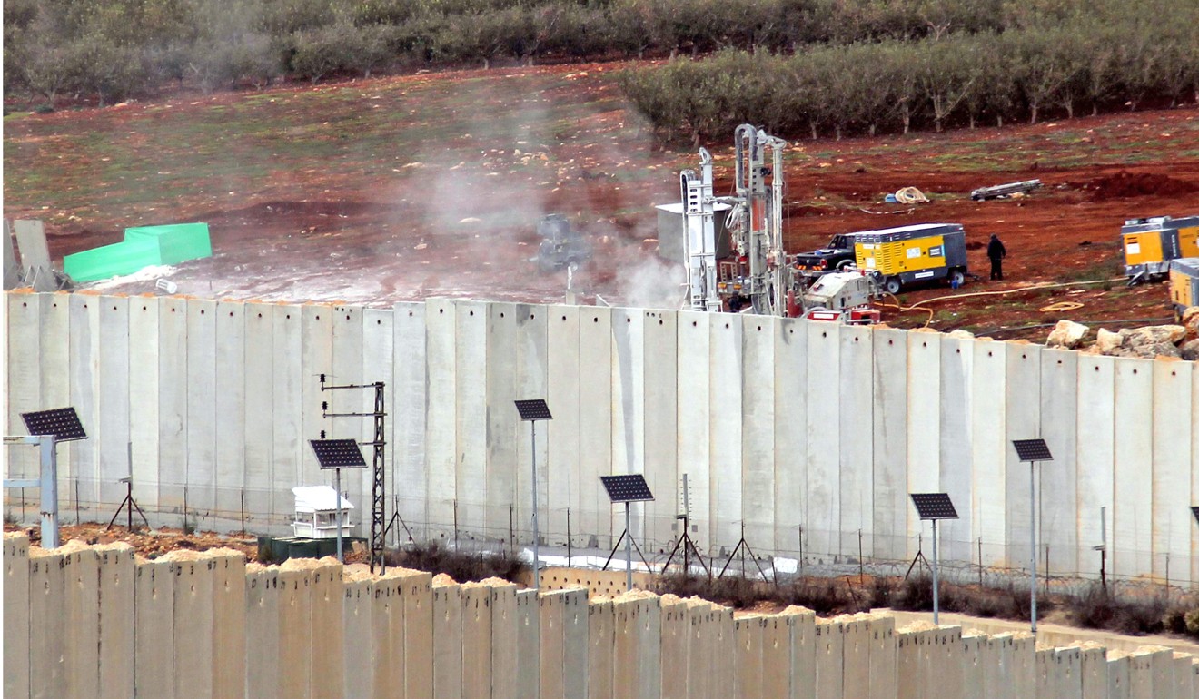 This picture taken on Tuesday from the southern Lebanese village of Kfar Kila shows Israeli machinery operating by the border wall in Israel. Photo: AFP
