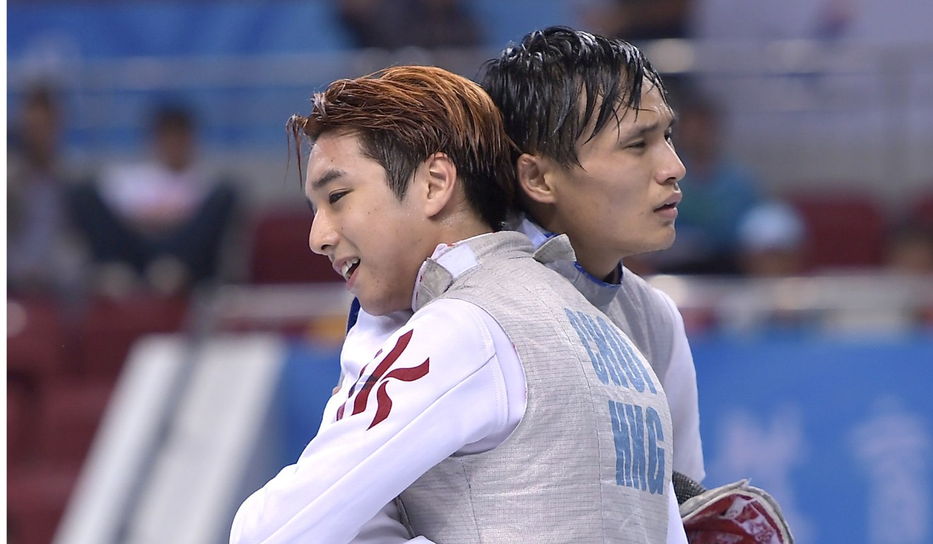 Nicholas Choi and Chen Haiwei embrace after their foil final at the China National Games. Photo: Xinhua