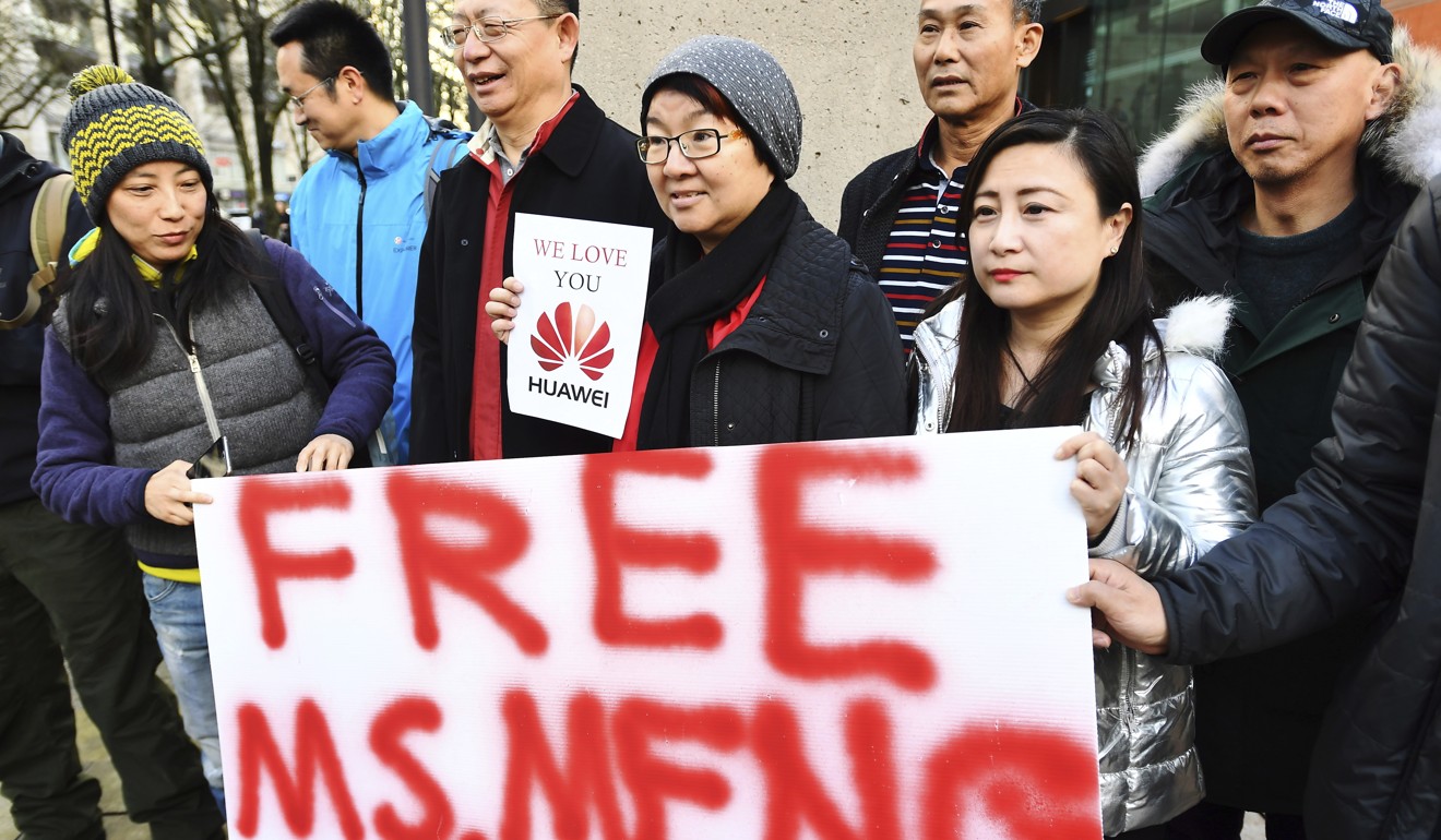 Supporters of Meng Wanzhou hold up a sign demanding her release outside her bail hearing fin Vancouver on Monday. Photo: AP