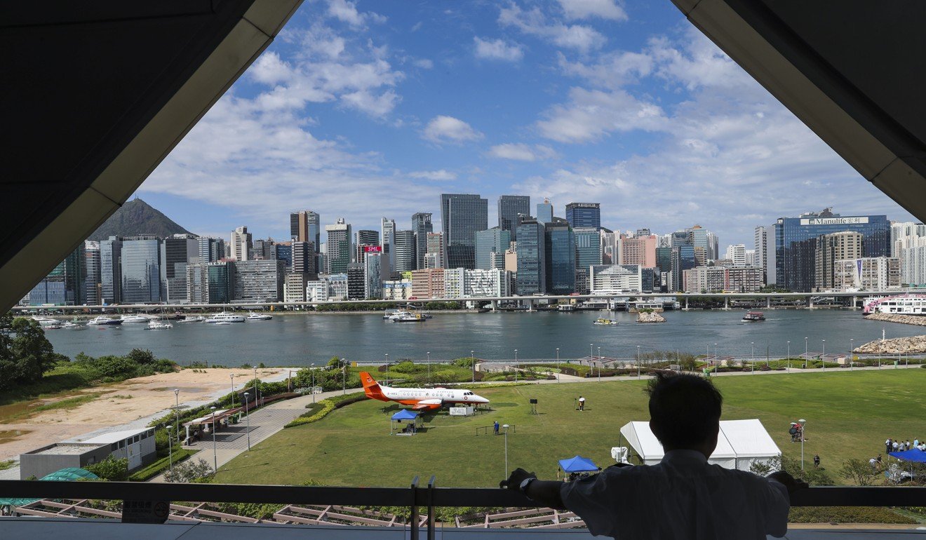 An aircraft is on display at Kai Tak Runway Park in Kai Tak, with buildings in Kwun Tong forming the backdrop. JLL says these two districts are new options for businesses to set up shop. Photo: K.Y. Cheng