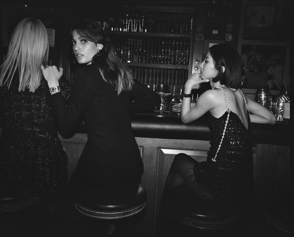 Soo Joo Park, Alma Jodorowsky and Nozomi Iijima wear the new CODE COCO luxury timepiece by Chanel in the hotel bar at the Ritz Paris.