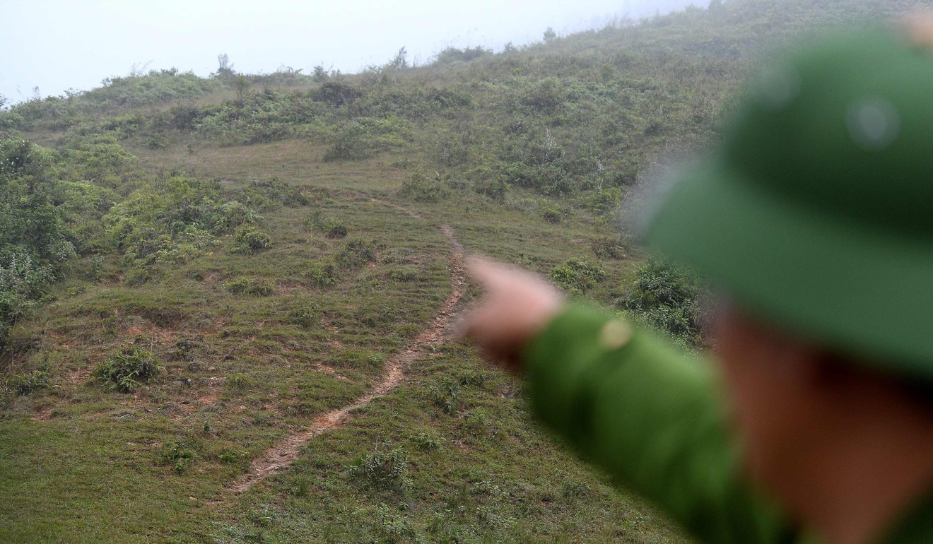 Police officer Trieu Phi Cuong points at the porous border separating Vietnam from China. Photo: AFP