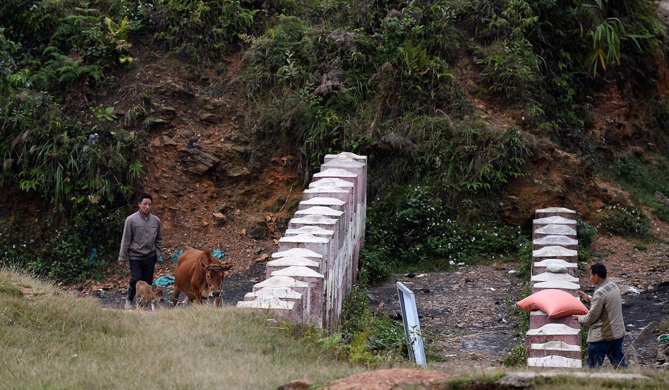 In some places, concrete posts are all that separate the two countries. Photo: AFP