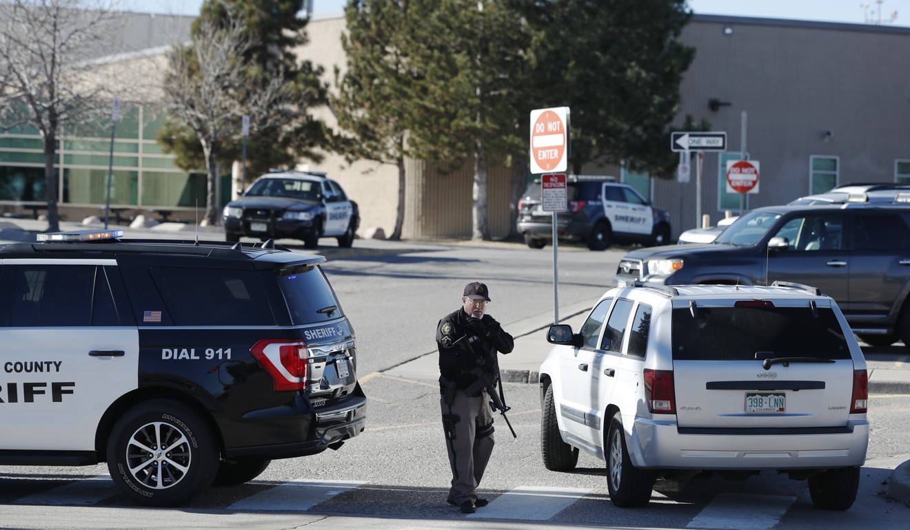 A sheriffs department officer stands guard outside the main driveway to Columbine High School on December 13, 2018, in Littleton, Colorado. Photo: AP