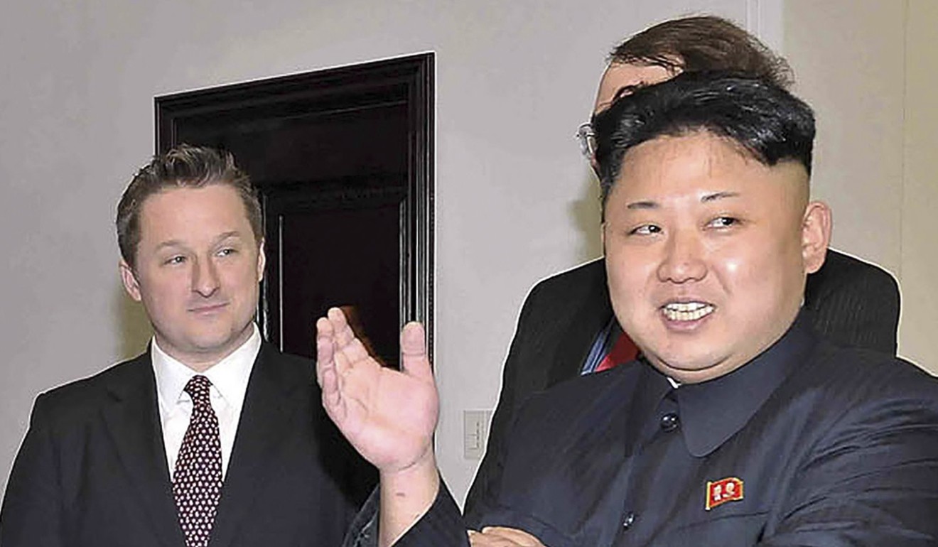Michael Spavor (left) listens as North Korean leader Kim Jong-un speaks with former US basketball star Dennis Rodman (not pictured) in Pyongyang in 2014. Photo: KCNA via KNS / AFP