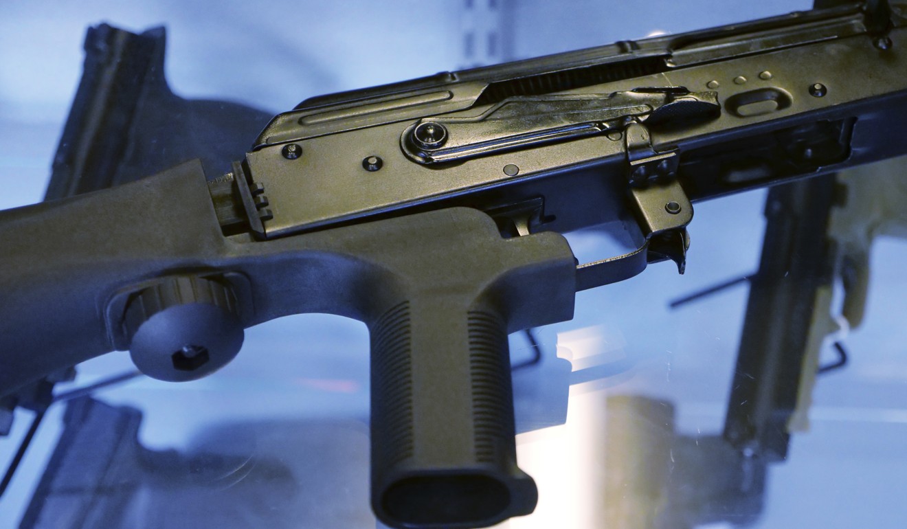 A bump stock is attached to a semi-automatic rifle at the Gun Vault store and shooting range in South Jordan, Utah. Photo: AP