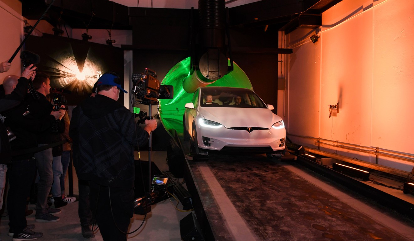 Elon Musk arrives in a modified Tesla Model X electric vehicle. Photo: AFP