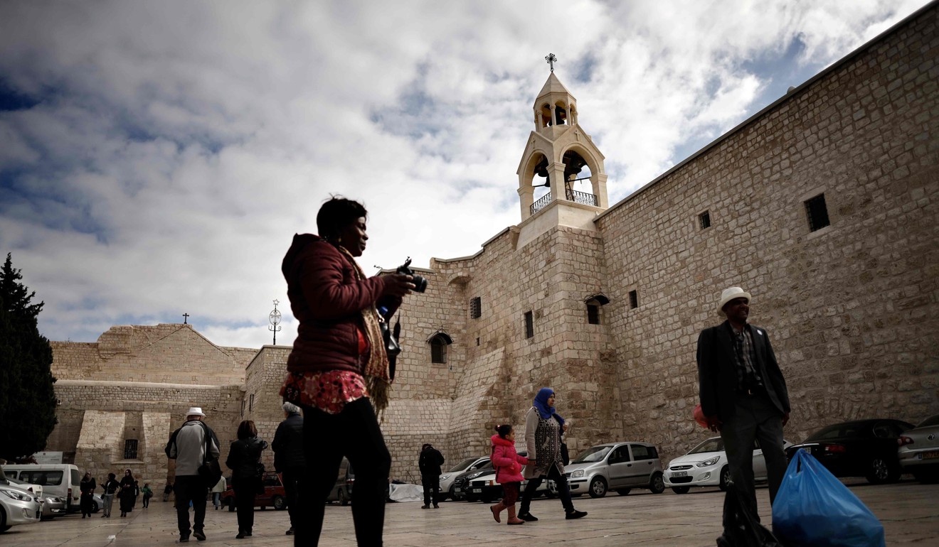 Tourists and Christian pilgrims take pictures outside the Church of the Nativity, revered as the site of Jesus Christ's birth. Photo: AFP