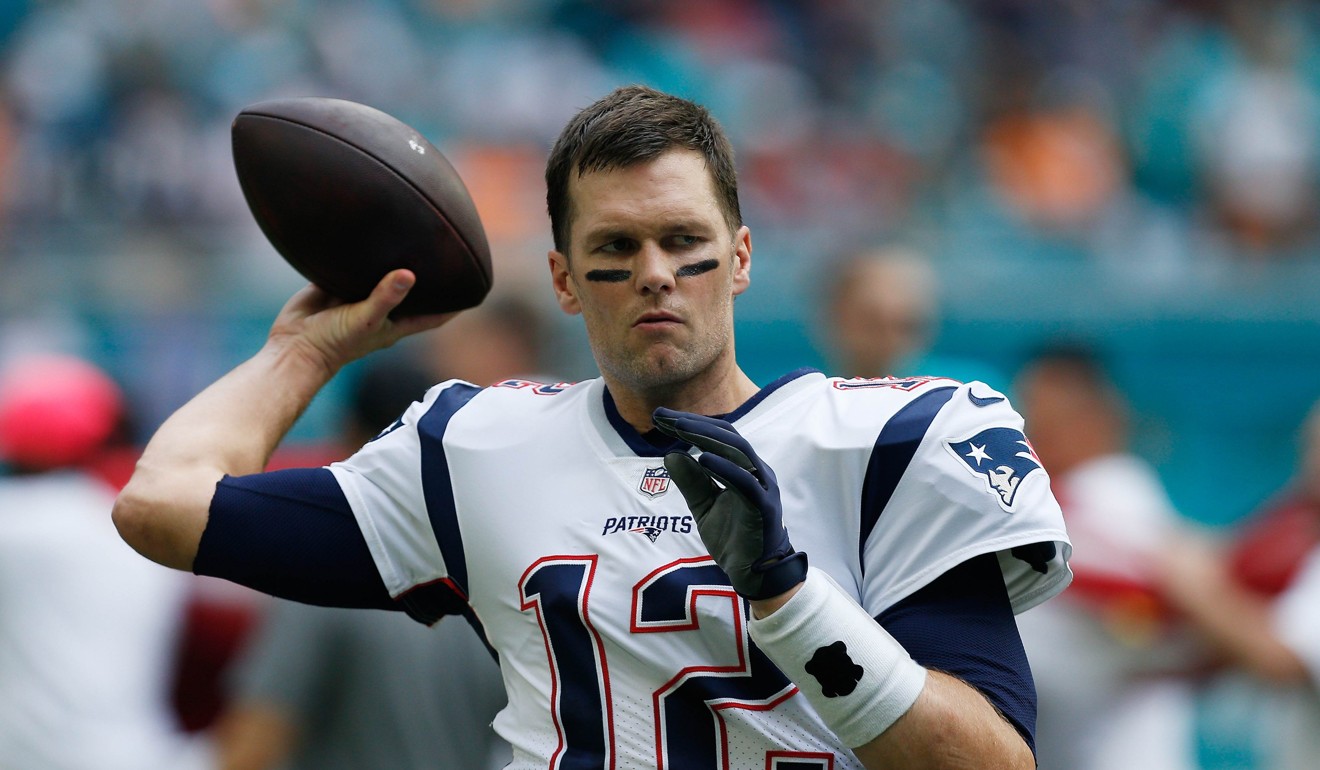 Tom Brady, number 12 of the New England Patriots, warms up before a game against the Miami Dolphins at Hard Rock Stadium on December 9. Photo: Michael Reaves / Getty Images / AFP