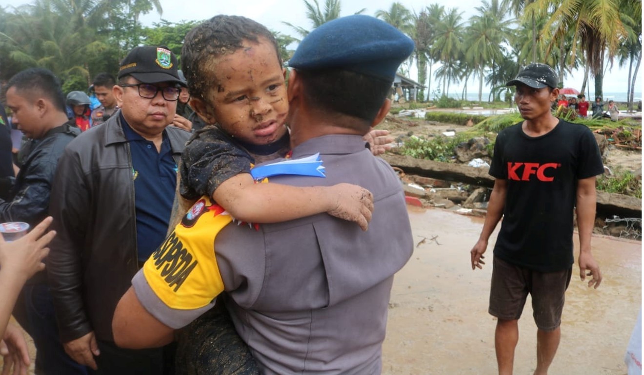 An injured boy is carried by a police officer after being found in a hotel that collapsed due to the tsunami at Carita in Pandeglang, Banten province, Indonesia on December 23, 2018. Photo: Banten Police Headquarters/Reuters