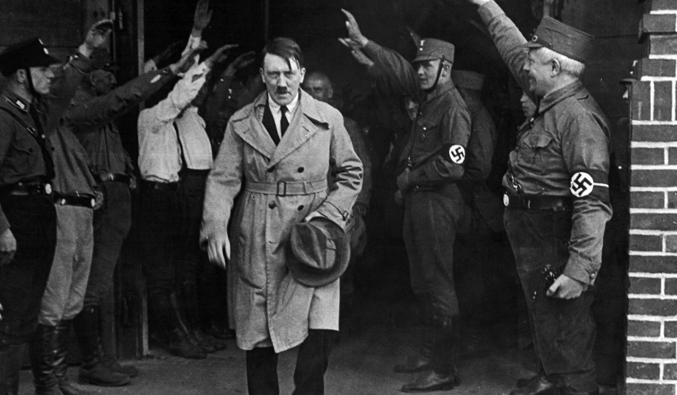 In this December 5, 1931 file photo, Adolf Hitler, is saluted as he leaves the Nazi party's Munich headquarters. Photo: AP