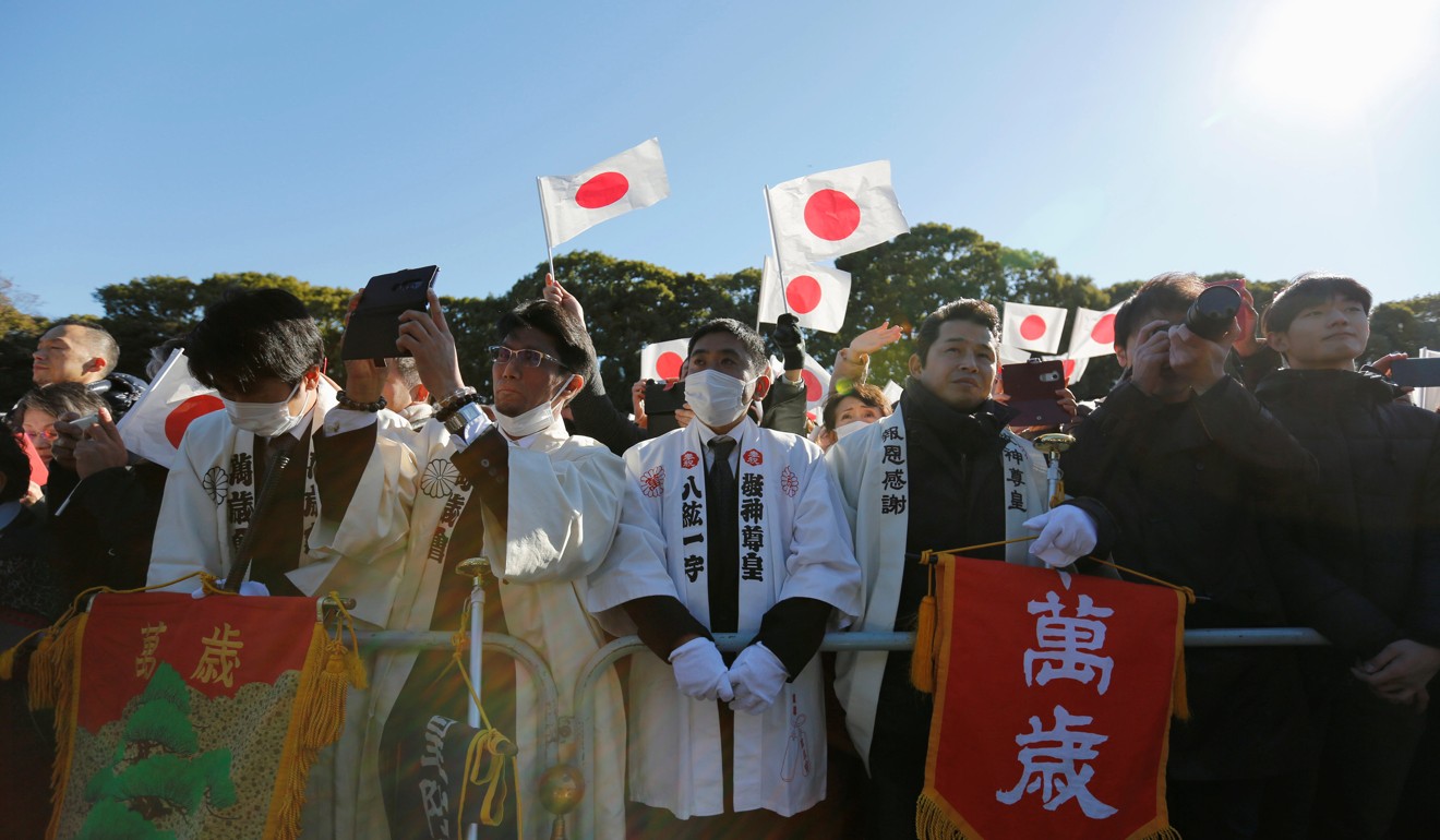 Well-wishers wave Japanese national flags during Akihito’s appearance at the Imperial Palace. Photo: Reuters