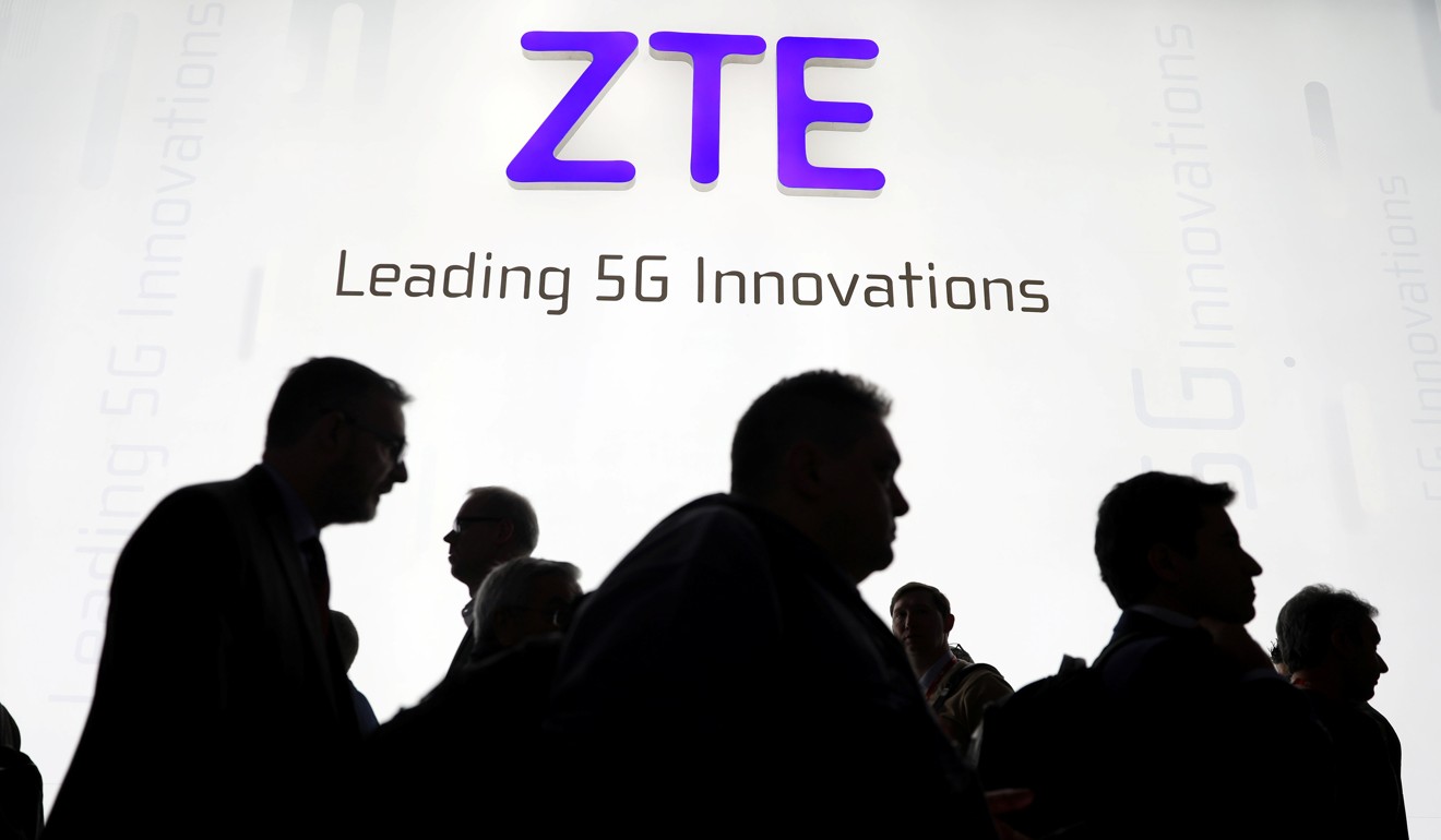 Visitors pass a ZTE booth at the Mobile World Congress in Barcelona on February 26, 2018. Photo: Reuters