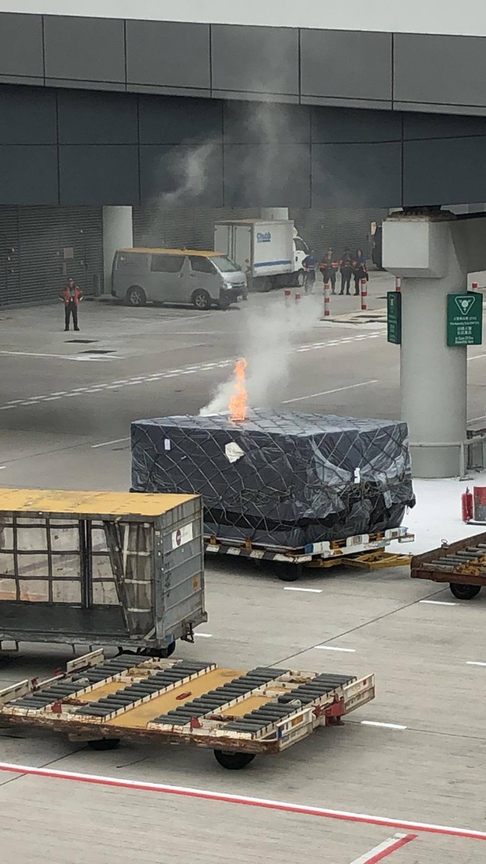 Photo from a Hong Kong Aviation Discussion Board group. Flames on a cargo pallet as it awaited loading onto a Hong Kong Airlines plane bound for Taipei. Source: Facebook