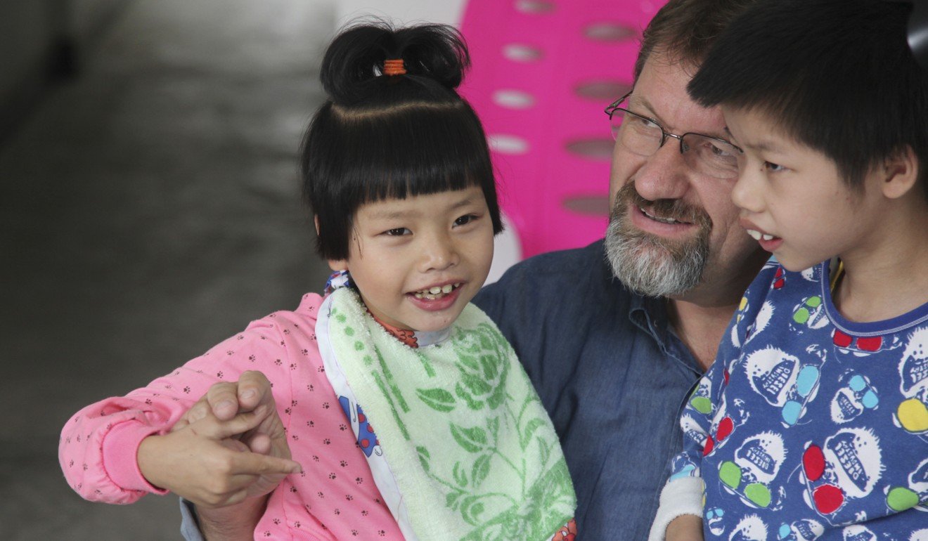Glover with children in Chengdu. Picture: Care For Children