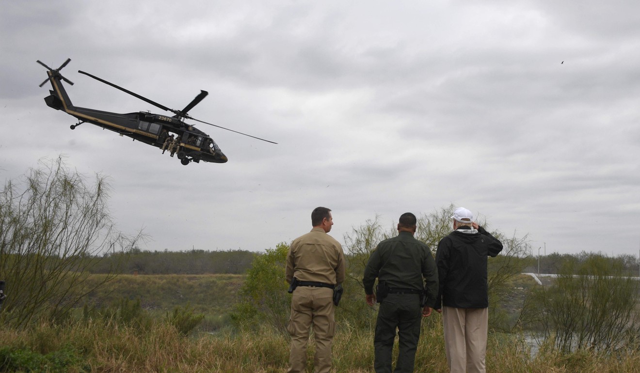 US President Donald Trump salutes with Border Patrol agents at the Rio Grande as a US Customs and Border Protection (CBP) helicopter flies over after his visit to US Border Patrol McAllen Station in McAllen, Texas, on January 10, 2019. Photo: AFP