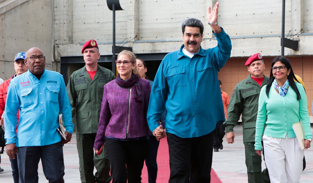 Venezuela's President Nicolas Maduro and his wife Cilia Flores, attend a meeting with supporters in Caracas on Tuesday. Photo: Reuters