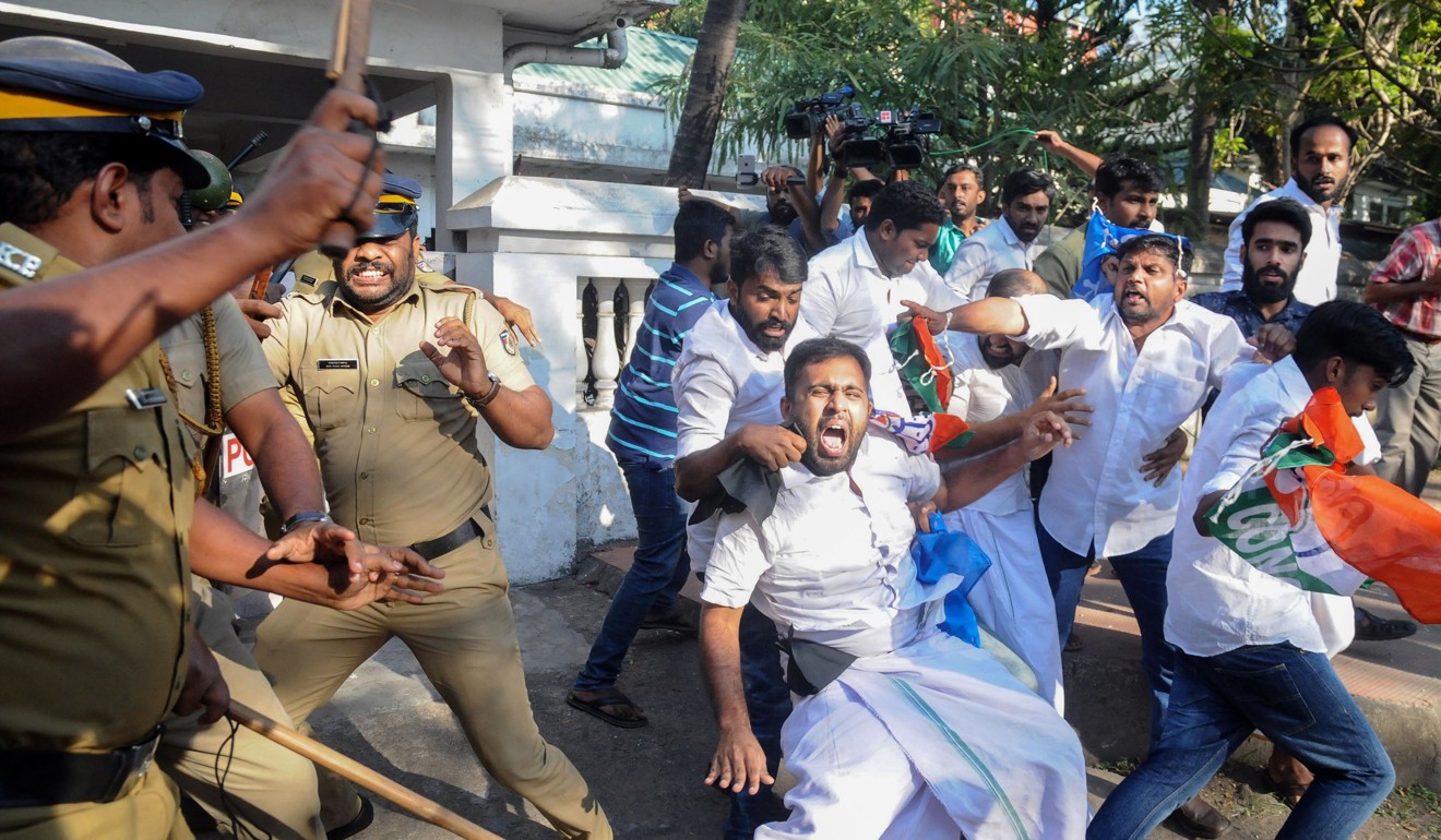 Indian police beat protesters during a demonstration in Kerala after two women entered a temple. Photo: STR/ AFP