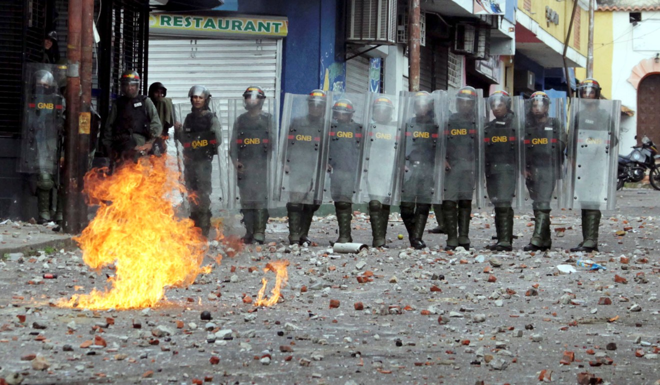 Security forces clash with opposition supporters participating in a rally against Venezuelan President Nicolas Maduro's government. Photo: Reuters