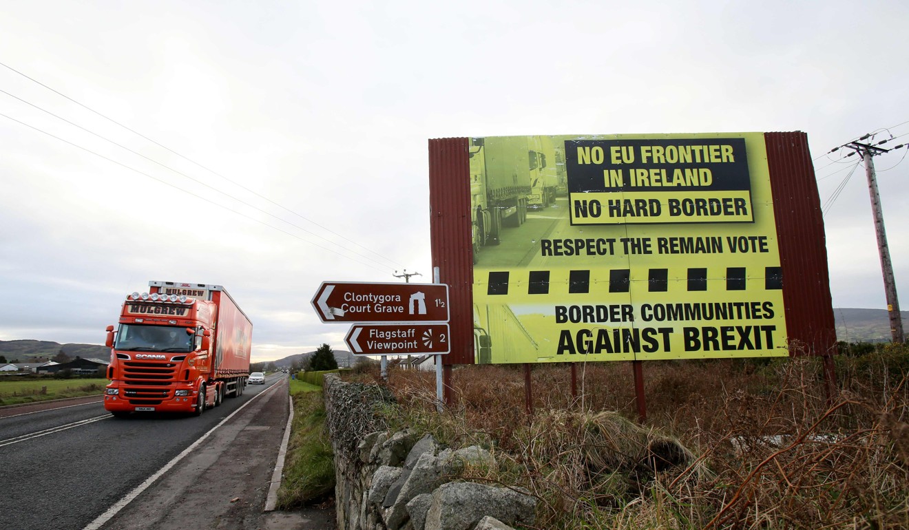 Traffic passes an anti-Brexit poster at the border between Northern Ireland and the Republic of Ireland. The question of an Irish backstop – designed to prevent the return of a hard border between Ireland and Northern Ireland after the UK leaves the EU – continues to bedevil Brexit negotiations. Photo: AFP