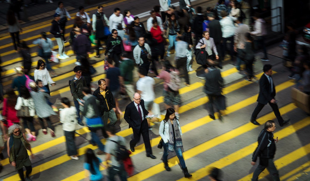 Pedestrians cross a road in Central. Photo: Bloomberg