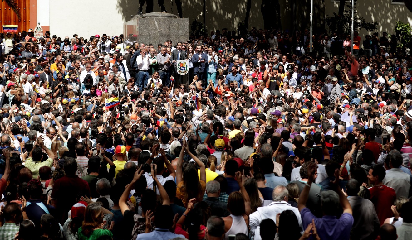 Crowd surrounding Guaido at the rally in Caracas on Friday. Photo: EPA-EFE