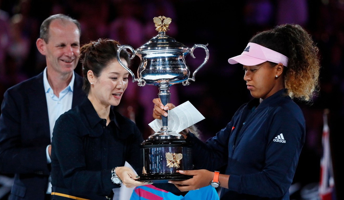 Naomi Osaka receives the Australian Open trophy from China’s former tennis player Li Na. Photo: AFP