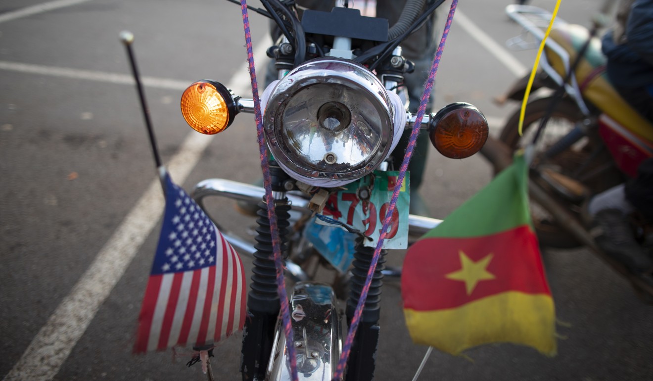 A Chinese-made motorcycle decorated with Cameroon and US flags is seen in Yaounde, Cameroon. China’s trade with sub-Saharan Africa has declined in recent years but in 2017 still surpassed America’s trade with Africa. Photo: EPA-EFE