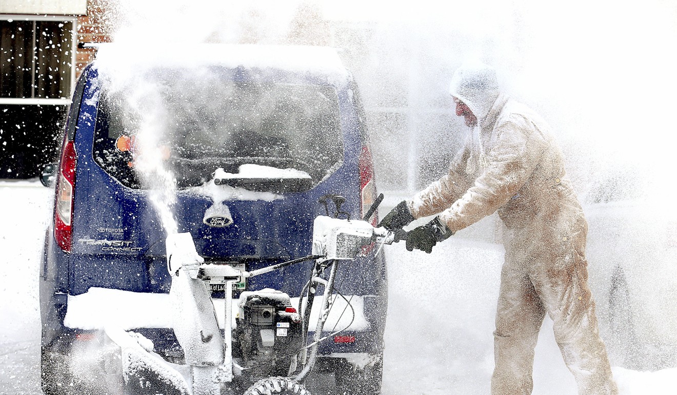 Holiday Inn & Suites employee John Mills clears snow from the hotel's car park in La Crosse, Wisconsin. Photo: AP
