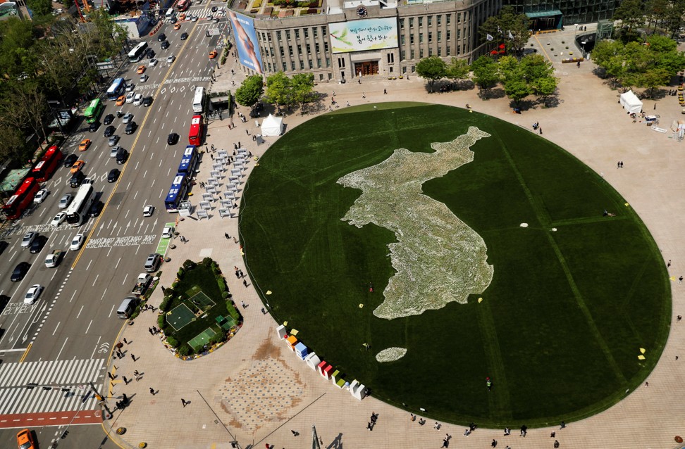 The shape of the Korean peninsula is seen on the lawn in front of City Hall in Seoul. Photo: Reuters