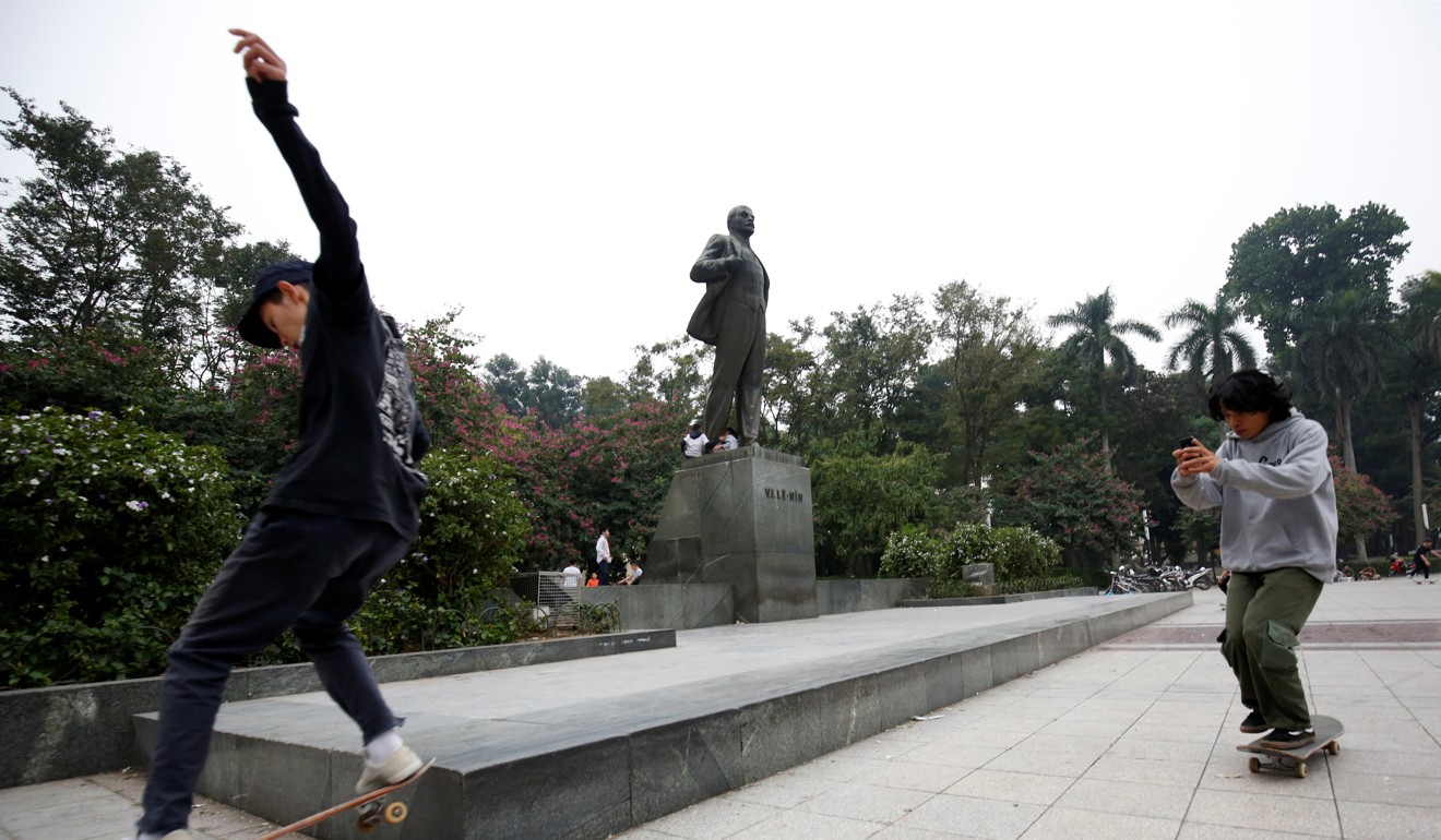 Vietnamese skateboards in front of an statue of Vladimir Lenin. Photo: Reuters