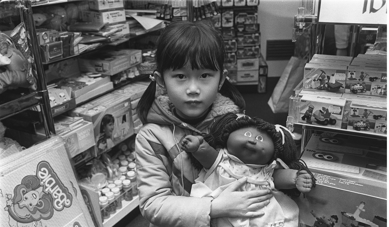 A little girl clutches her Cabbage Patch Kid in a toy store in Causeway Bay.