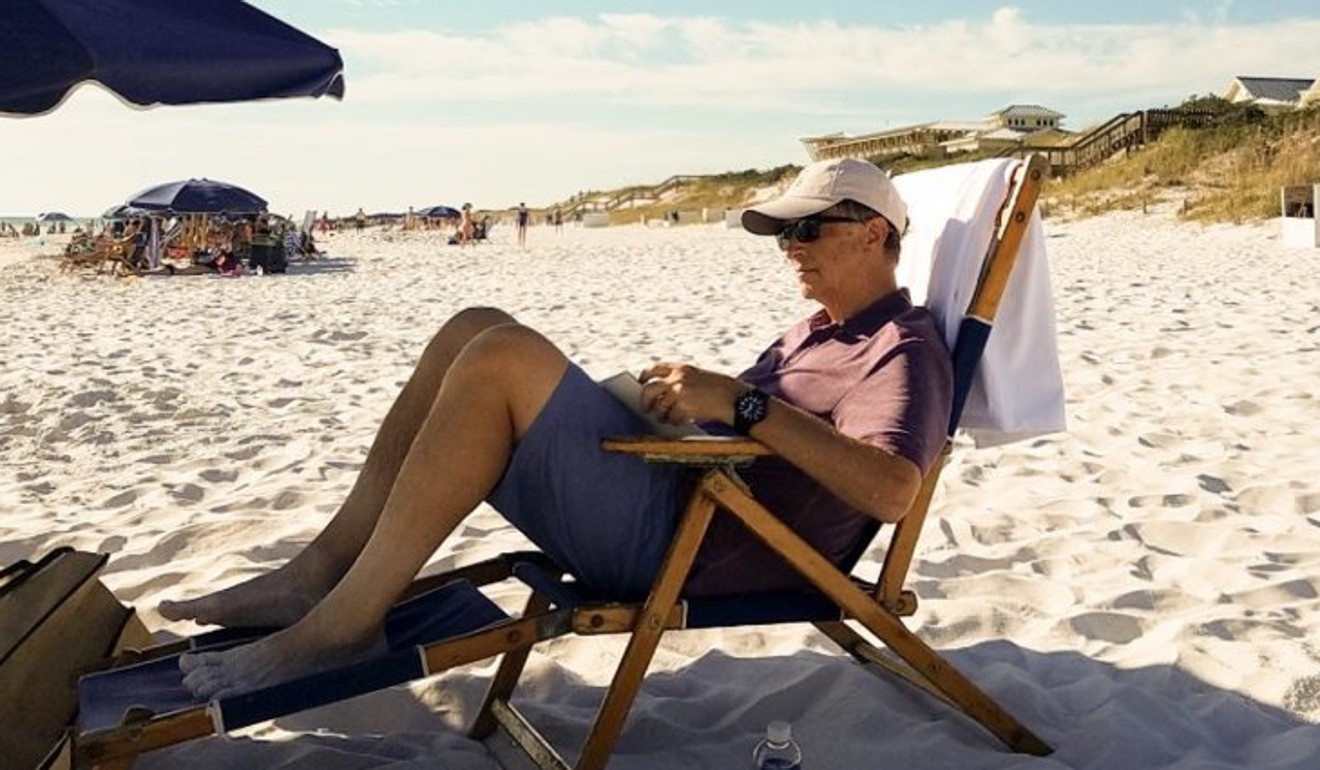 Bill Gates reads while relaxing on a beach. Photo: Bill Gates/Facebook