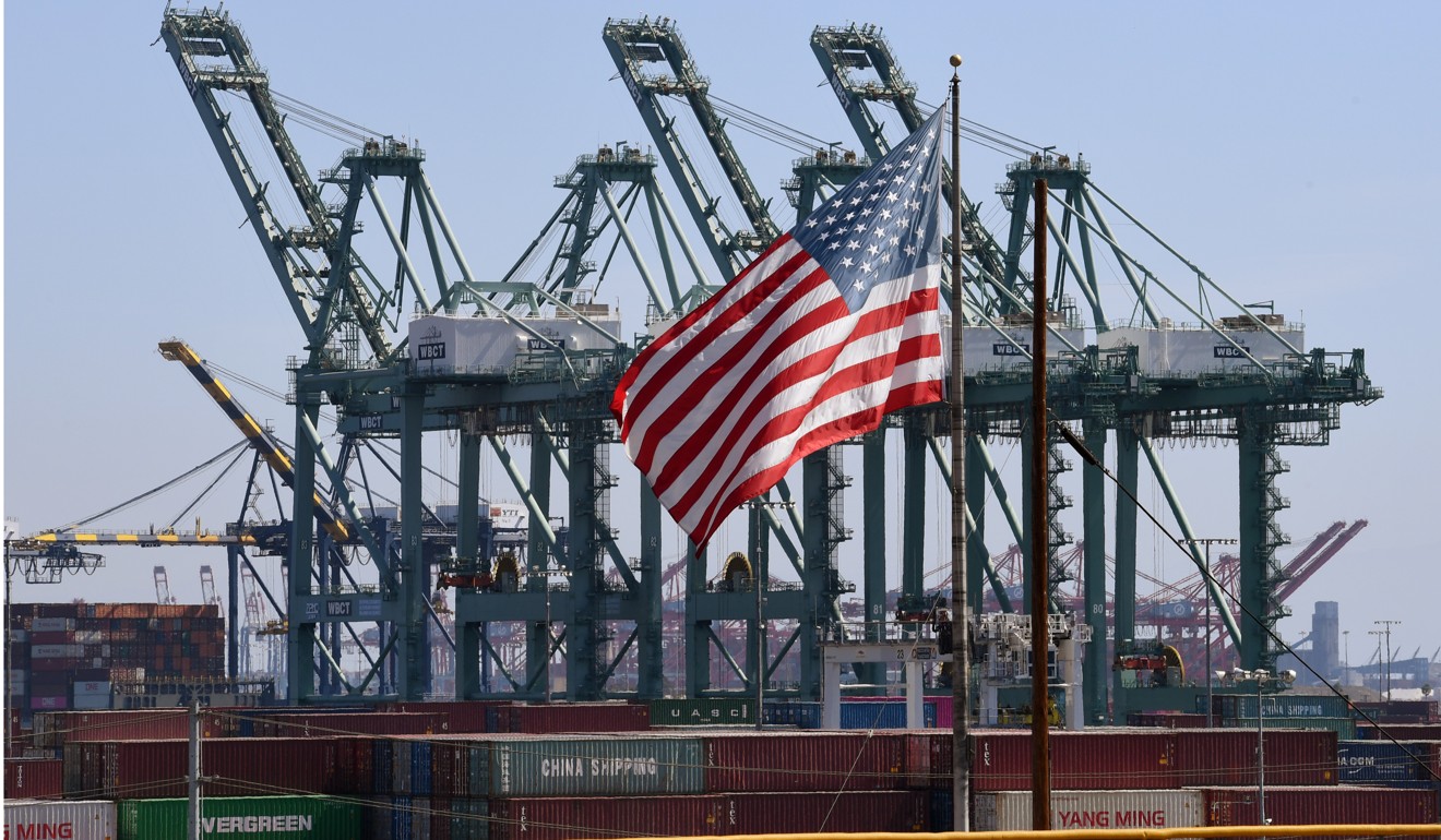 A US flag flies over Chinese shipping containers unloaded at the Port of Long Beach in Los Angeles on September 29, 2018. Photo: AFP