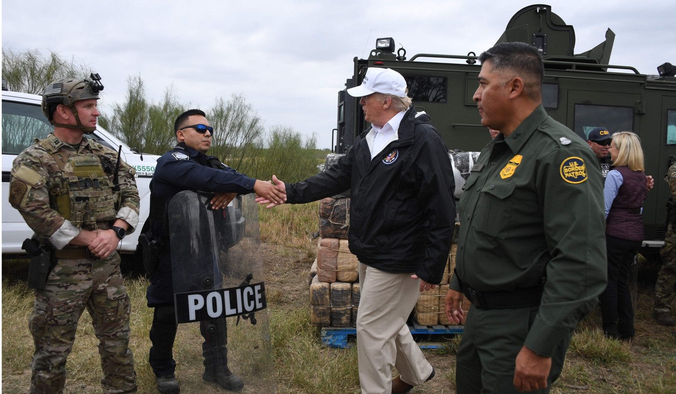 Trump greets a policeman with Border Patrol agents and the military during a visit to McAllen, Texas on January 10, 2019. Photo: AFP