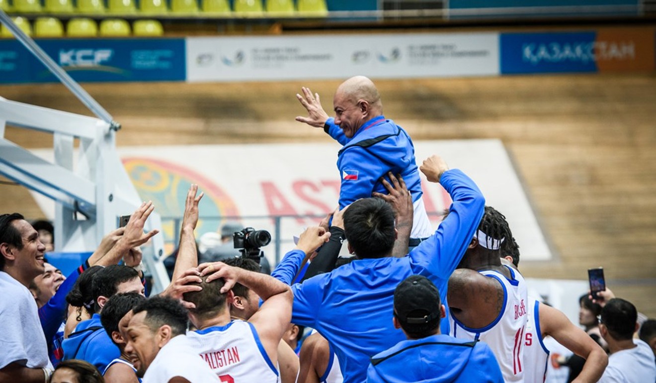 Gilas Pilipinas coach Yeng Guiao is carried by his players after their victory. Photo: Fiba