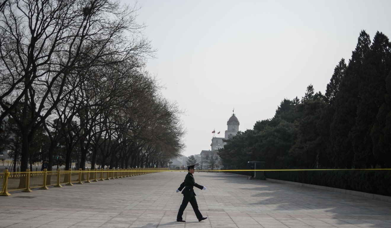 A Chinese paramilitary police officer patrols in front of the Great Hall of the People on Saturday on the eve of the opening session of the Chinese People’s Political Consultative Conference in Beijing. Photo: AFP