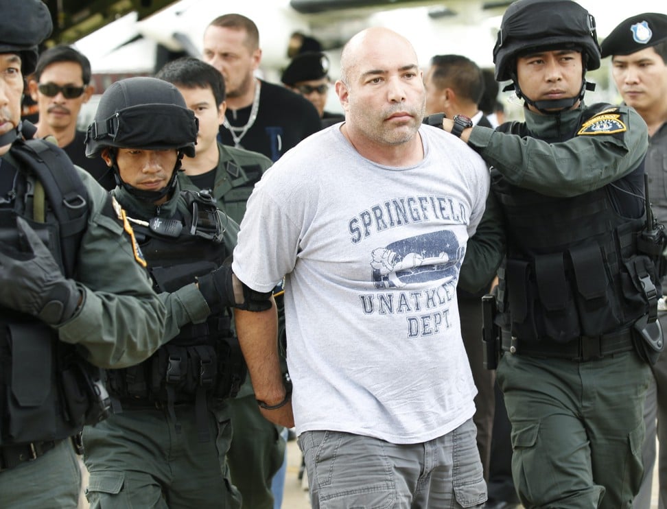 In this September 26, 2013 file photo, US mercenary Joseph Hunter is led away by Thai police commandos after being arrested in Bangkok. Photo: EPA