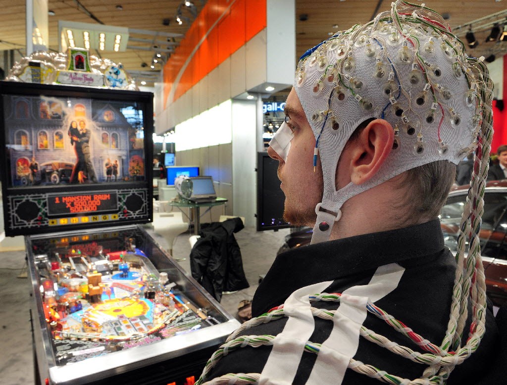 A man uses an EEG cap to play pinball at the CeBIT trade show in 2010. (Picture: AFP)