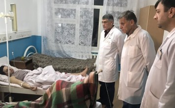Doctors examine the wounded man in the hospital after a shooting at a church in Kizlyar, Dagestan. Photo: EPA