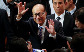 Hong Kong tycoon Li Ka-shing waves goodbye after announcing his retirement as the chairman of CK Hutchison Holdings and CK Asset Holdings, at the annual general meeting of the companies on May 10. But he’ll continue to serve as a senior adviser. Photo: Reuters