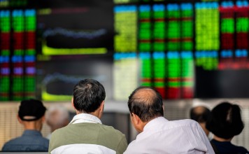 Investors monitor stock prices at a securities company in Shanghai on September 25. Despite an inflow of foreign cash, thanks to recent listings of Chinese stocks on key emerging market equity indices, mainland investors have shown scepticism about the state of the Chinese economy. Photo: AFP