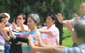 Older Chinese exercise in Ditan Park in Beijing in June 2016. Beijing's parks have become a common place for older people to spend their time in the morning, where they can gather with friends or take care of their grandchildren. Photo: Simon Song