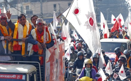 Ishwor Pokhrel (second left), general secretary of Communist Party of Nepal-Union Marxist and Leninist, takes par in an election victory rally in Kathmandu on Tuesday. Photo: EPA