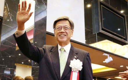 Okinawa Governor Takeshi Onaga waves to his supporters at a fundraising party in Naha. Photo: Kyodo