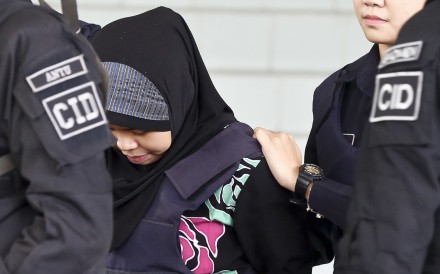 Indonesian Siti Aisyah – accused of killing Kim Jong-nam – is escorted by police as she leaves after a court hearing in Malaysia on Tuesday. Photo: Photo: AP
